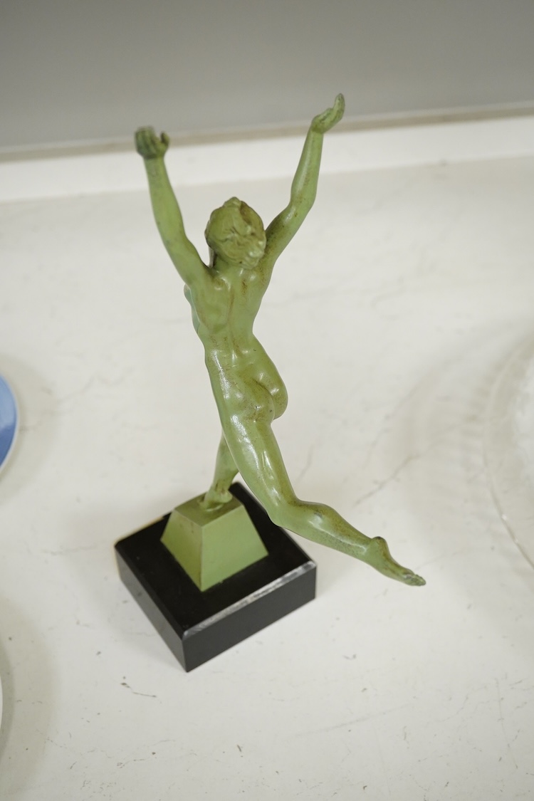 An Art Deco patinated spelter figurine of a nude dancer raised on black and green onyx base, 29cm high